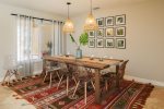 A charming farmhouse styled dining table comfortably sits eight